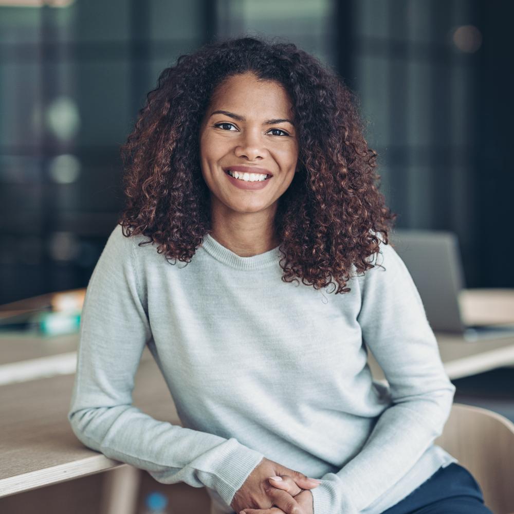 Young smiling businesswoman sitting at a table